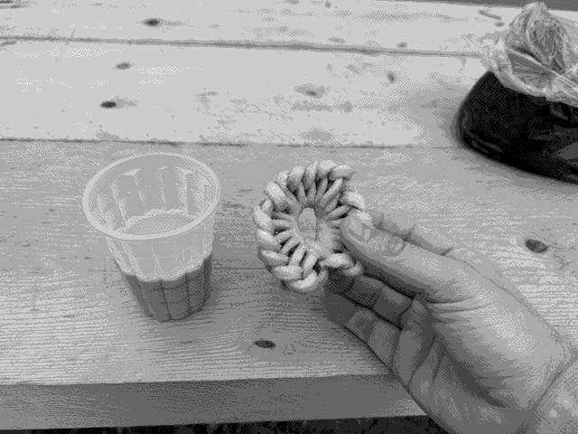 A cup of suja with a handmade, local biscuit.