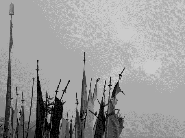 The tips of prayer flags seen here on a cloudy day. It's customary to plant 108 of these flags in memory of a deceased loved one.