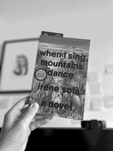 a copy of 'When I Sing, Mountains Dance'  in its natural environment.
